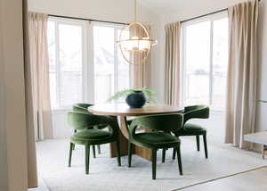 Dining area featuring a healthy amount of sunlight, a chandelier, and light hardwood / wood-style floors