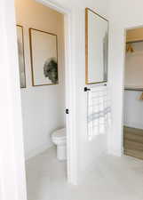 Bathroom with tile patterned floors and toilet