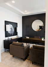 Living room featuring a tray ceiling and light carpet
