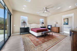 Bedroom with ceiling fan, light hardwood / wood-style floors, ensuite bath, and access to exterior