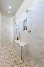 Bathroom featuring a tile shower