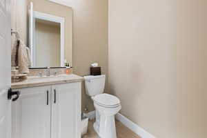 Bathroom with vanity, toilet, and hardwood / wood-style floors