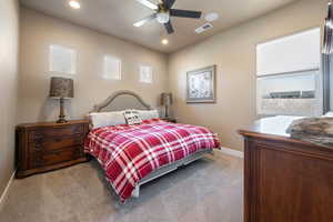 Bedroom with light colored carpet and ceiling fan