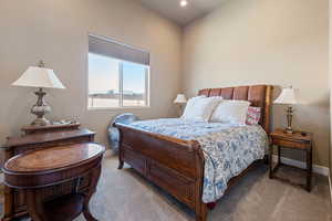 Bedroom featuring light carpet