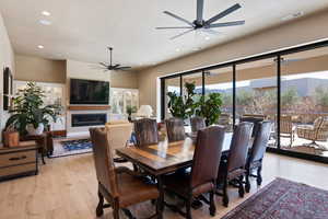 Dining area with ceiling fan and light hardwood / wood-style flooring