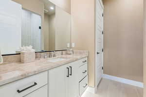 Bathroom with tile patterned floors and vanity