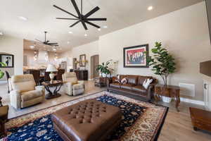 Living room featuring ceiling fan and light wood-type flooring