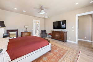 Bedroom featuring light hardwood / wood-style floors and ceiling fan