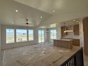 Kitchen with recessed lighting, open floor plan, a center island with sink, and baseboards