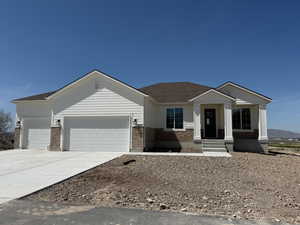 Single story home featuring driveway, a shingled roof, brick siding, and a garage