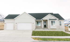 View of front of home featuring a mountain view and a garage