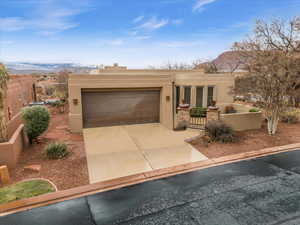 Southwest-style home featuring a mountain view and a garage