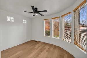 Spare room with ceiling fan and light hardwood / wood-style floors