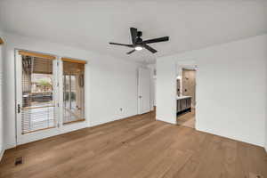 Empty room featuring light wood-type flooring and ceiling fan