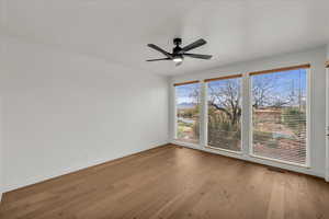 Unfurnished room with light hardwood / wood-style flooring and ceiling fan