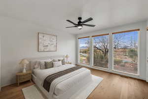 Bedroom with light wood finished floors and ceiling fan