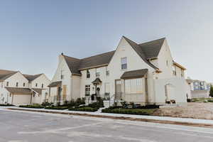 View of front of house with a residential view and stucco siding