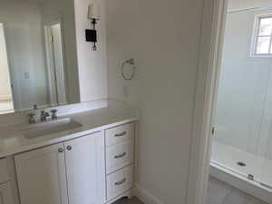 Bathroom featuring vanity and a stall shower