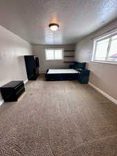 Unfurnished bedroom with carpet flooring and a textured ceiling