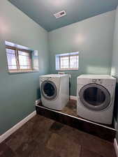 Laundry area featuring independent washer and dryer and a textured ceiling