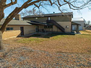 Rear view of property featuring a yard and a patio area