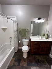 Full bathroom featuring shower / bathtub combination with curtain, vanity, and toilet