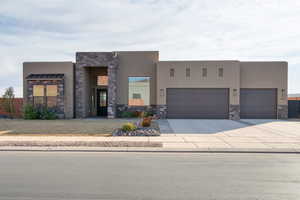 Pueblo-style house with a garage