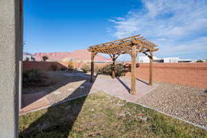 View of yard featuring a patio area, a pergola, and a mountain view