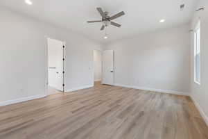 Spare room featuring ceiling fan and light hardwood / wood-style flooring