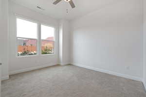 Unfurnished room with light carpet and ceiling fan