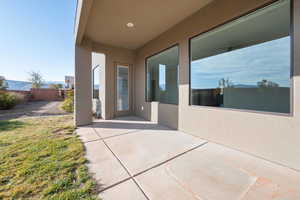 Doorway to property featuring a patio area