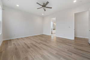 Spare room featuring ceiling fan and light hardwood / wood-style flooring