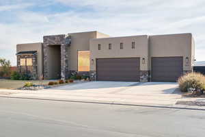 Pueblo revival-style home with a garage