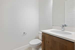 Bathroom featuring tile patterned floors, vanity, and toilet