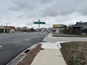 View of street with sidewalks, curbs, and street lights