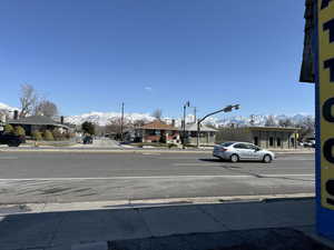View of road with sidewalks, a residential view, and curbs