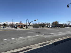 View of street featuring curbs, sidewalks, and a mountain view