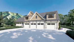 View of front of property with a mountain view and a garage