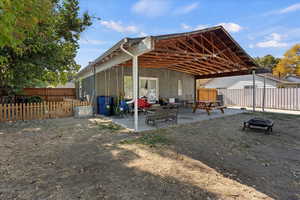 Rear view of property with a patio and a fire pit