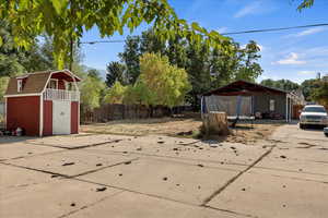 Exterior space with a trampoline and a storage shed