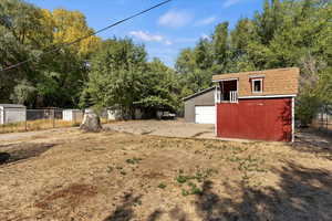 View of yard with a garage and a storage unit