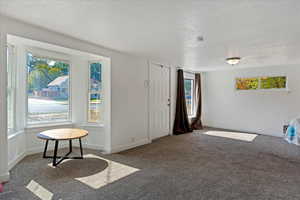 Interior space with a textured ceiling and a wealth of natural light