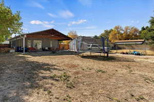 View of yard featuring a trampoline