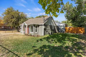 View of side of property featuring central AC and a lawn