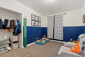 Carpeted bedroom with a textured ceiling