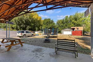 Exterior space with a trampoline, a storage unit, and a fire pit