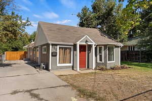 Bungalow featuring a patio and a front lawn