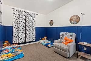 Bedroom with carpet floors and a textured ceiling