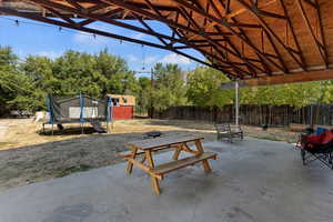 View of patio featuring a shed and a trampoline