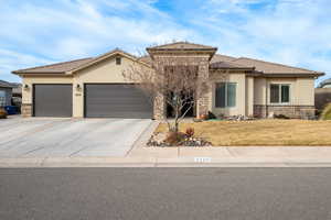 View of front of home featuring a garage and a front yard